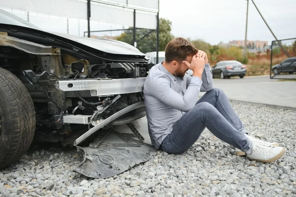 Man feeling headache caused during car wreck.