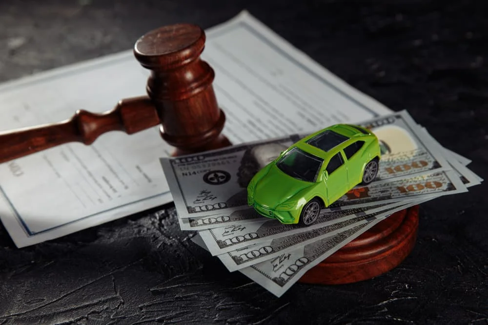 Judge Gavel, money and toy car on a table