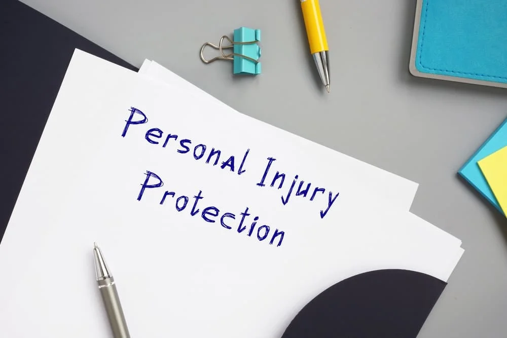 Personal Injury Protection with phrase on the piece of paper.